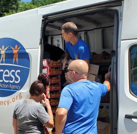 Volunteer Chris Varrette helps distribute food from Access’ current mobile food delivery van, set up at 1315 Main St. in Willimantic. (Contributed Photo)